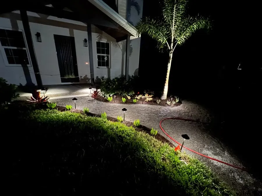 Low voltage landscape lighting illuminating a property at dusk